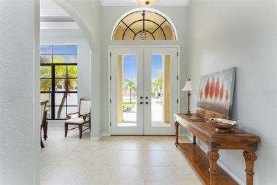 Double door entry with arched window above lets in plenty of natural light! | Image 3