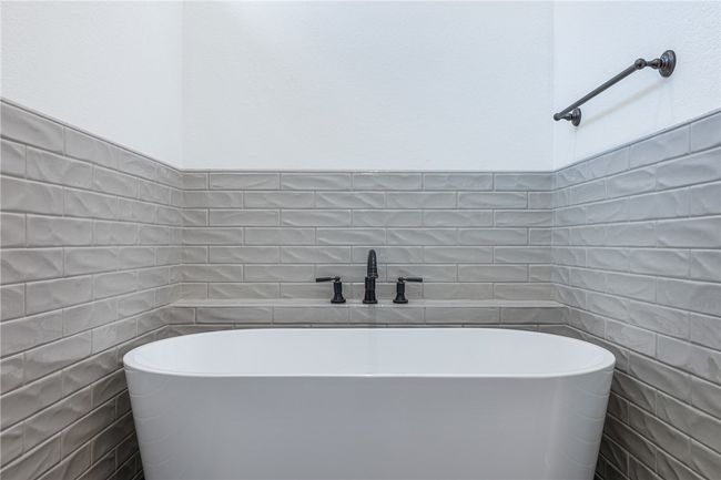 Bathroom featuring tile walls and a bath | Image 19