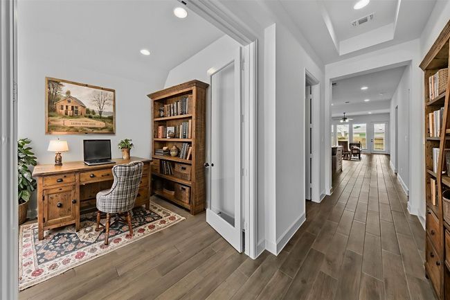 Office space with dark wood finished floors and recessed lighting | Image 5