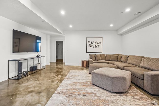 Living area featuring concrete flooring and recessed lighting | Image 29