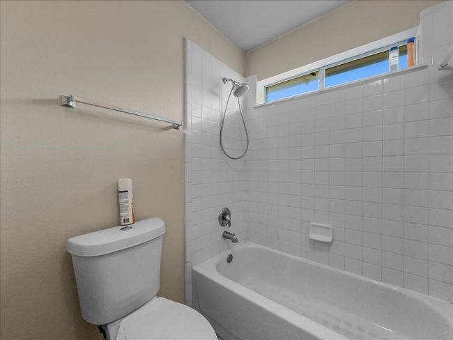 Full bathroom featuring washtub / shower combination and toilet | Image 21