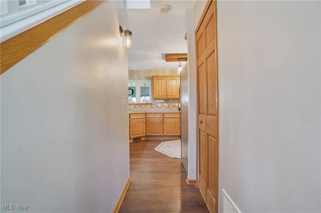 Hall featuring dark wood-type flooring, visible vents, and baseboards | Image 23