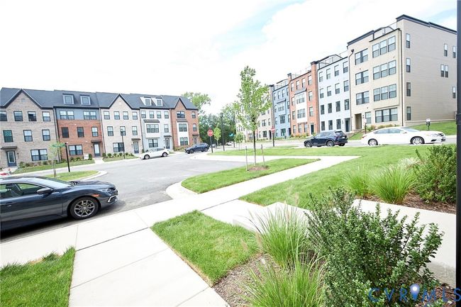 View of asphalt street with traffic signs and sidewalks | Image 7