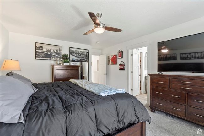 Bedroom with light colored carpet and ceiling fan | Image 17