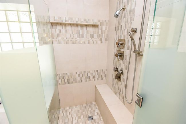 The shower features body sprays, hand wand, bench, shampoo and soap shelf, all done in style! | Image 30
