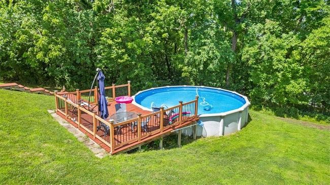Pool featuring a lawn and a deck | Image 31