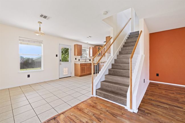 Stairway with baseboards and wood finished floors | Image 15