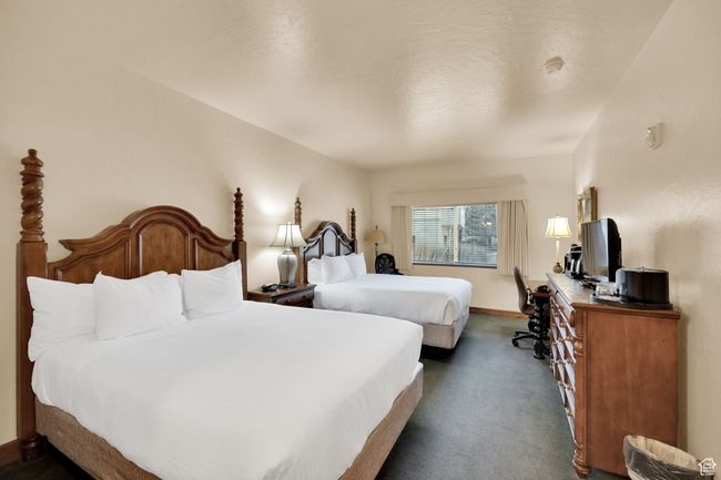 Bedroom featuring baseboards and dark colored carpet | Image 28