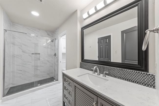 Full bath with vanity, tasteful backsplash, marble finish floor, and a marble finish shower | Image 31