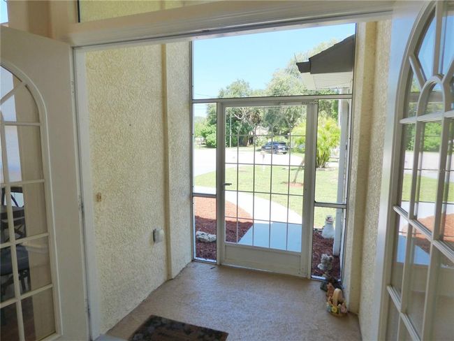 very comfortable screened porch with high ceiling and double entry door | Image 9