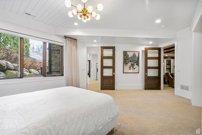 Bedroom with light carpet, a notable chandelier, visible vents, and recessed lighting | Image 77