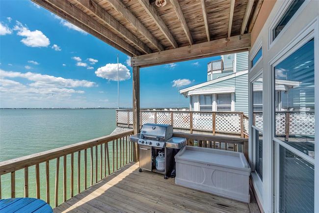 The upper deck has a covered area, with a grill included for outdoor cooking and relaxing. | Image 36