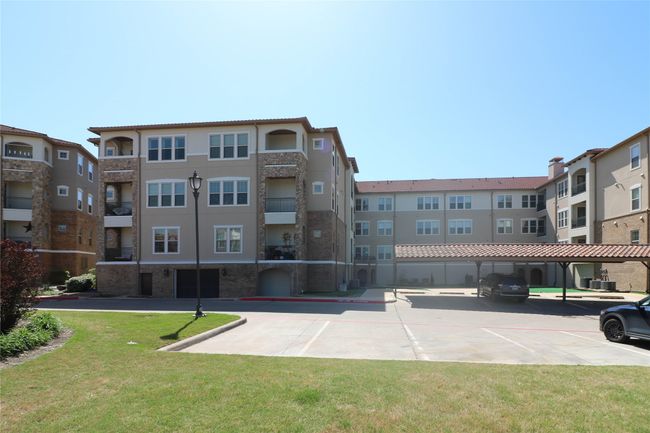 View of building exterior featuring a parking lot | Image 28