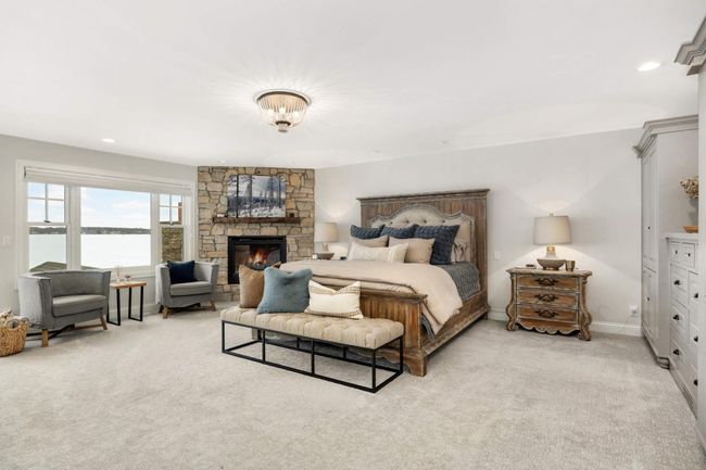 The perfect master with ample built in cabinets, fire place and one great lake view. | Image 23