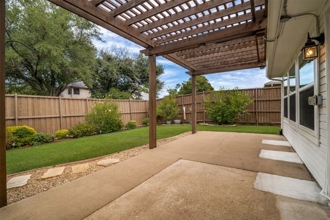 Fenced backyard with a patio area and a pergola | Image 25