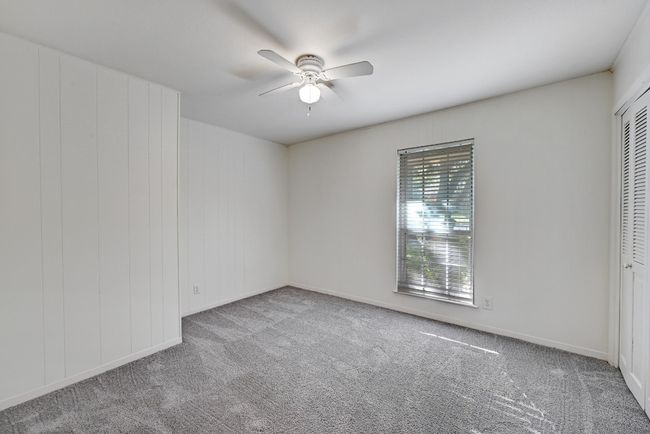 Carpeted spare room featuring baseboards and ceiling fan | Image 22