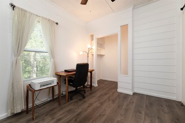 Office area with dark wood-style flooring, a ceiling fan, and wood ceiling | Image 18