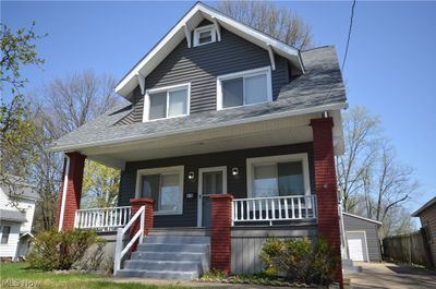 View of front of house with a garage, a porch, and an outdoor structure | Image 2