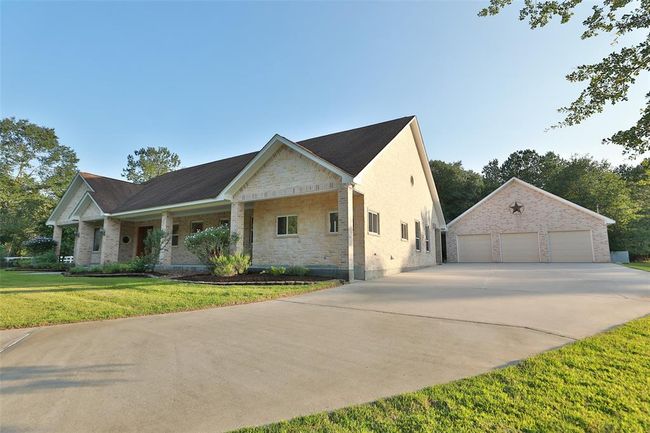Large 3 car garage. Electric point for battery charging and central vac outlet by each car. Covered breezeway from back door to garage and workshop. | Image 5