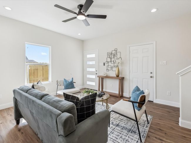 Living room with baseboards, wood finished floors, plenty of natural light, and ceiling fan | Image 5