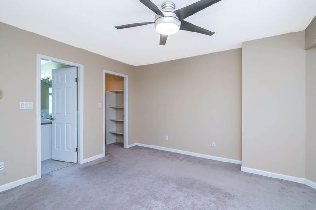 Unfurnished bedroom with a closet, carpet, baseboards, a ceiling fan, and a spacious closet | Image 21