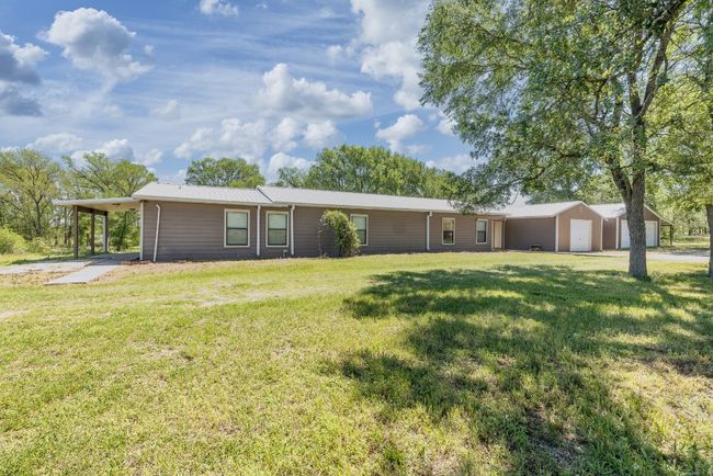 Ranch-style house with a front yard and an attached carport | Image 33