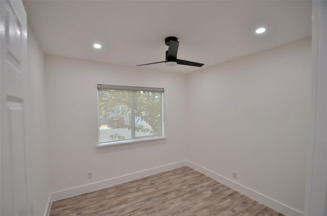 Empty room with recessed lighting, light wood-style flooring, and a ceiling fan | Image 10