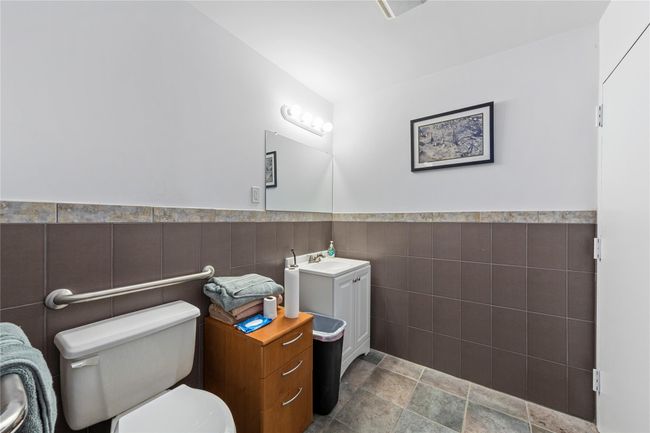 Bathroom featuring vanity, tile walls, and toilet | Image 38