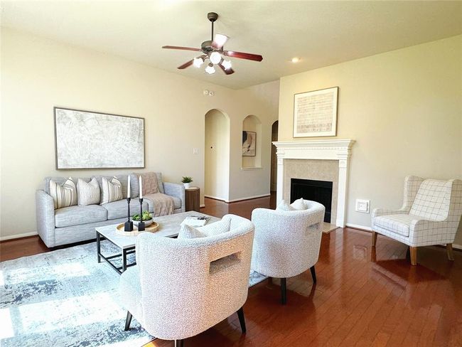 Family room is spacious as well and offers gleaming wood floors and a cozy fireplace | Image 12