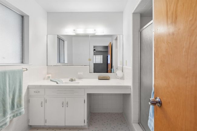 Full bathroom with vanity, tile walls, plenty of natural light, and a stall shower | Image 30