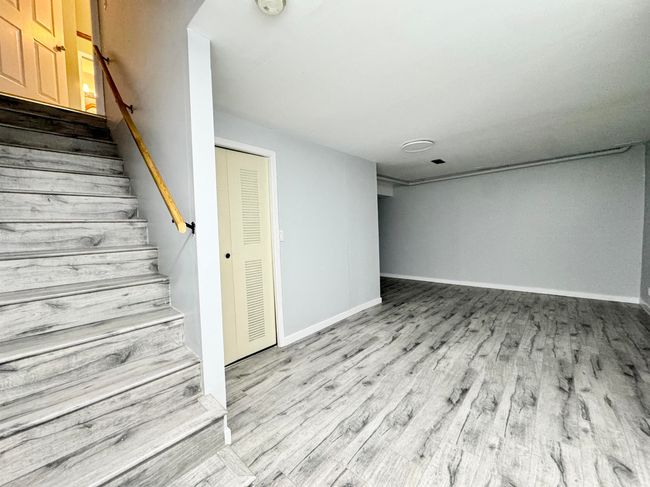 Below grade area featuring wood finished floors and stairway | Image 18