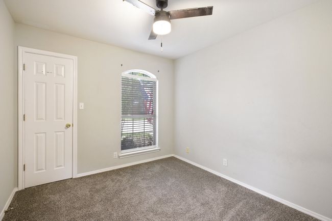 Empty room with dark carpet and a ceiling fan | Image 23