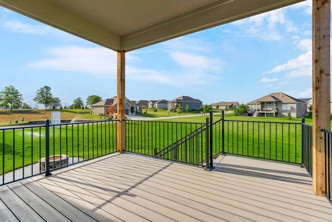Option to do a covered deck or patio to match this if preferred with stamped concrete and firepit. Photos of previous model home. Not actual listing. Features and sizes may vary. Contact agent for details & showings! | Image 29
