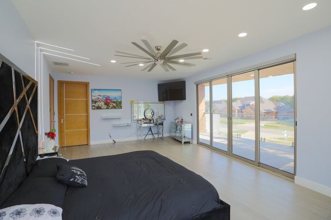 Unfurnished bedroom featuring ceiling fan, access to exterior, and light hardwood / wood-style flooring | Image 15