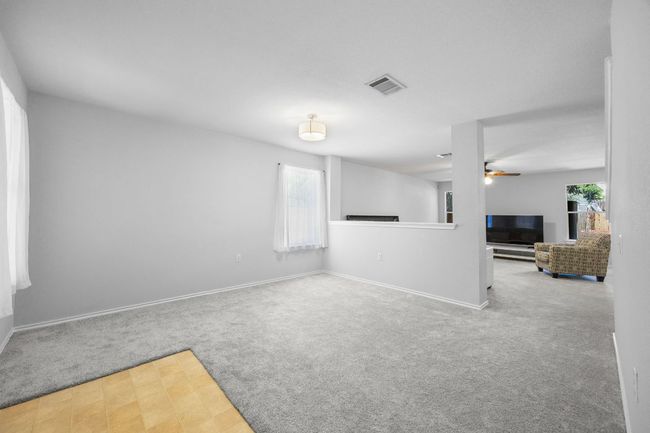 Half wall divides the front living room from the family room while still giving the home a spacious, open feel. | Image 4