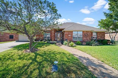 Ranch-style house with a garage and a front yard | Image 3