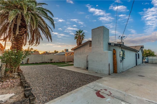 View of home's exterior featuring a patio, stucco siding, and a fenced backyard | Image 49