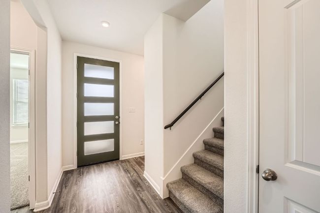 Entryway with stairway, baseboards, and dark wood-style flooring | Image 4