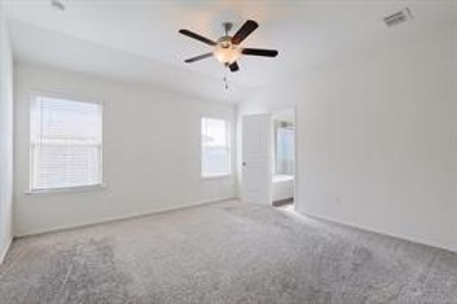 Carpeted empty room featuring a ceiling fan | Image 9