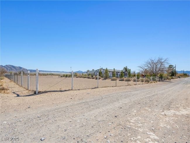 Northwest corner view of home featuring a rural view, a mountain view, and fence | Image 55
