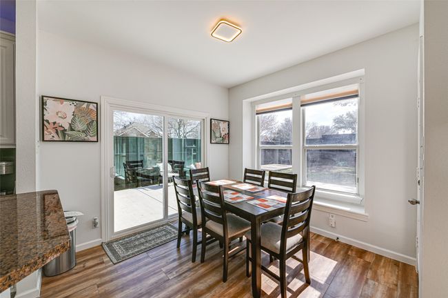 Dining area featuring a healthy amount of sunlight and dark hardwood / wood-style flooring | Image 8