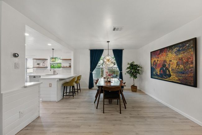 Freshly painted walls and stylish fixtures set the stage for both formal meals and casual dining. | Image 7