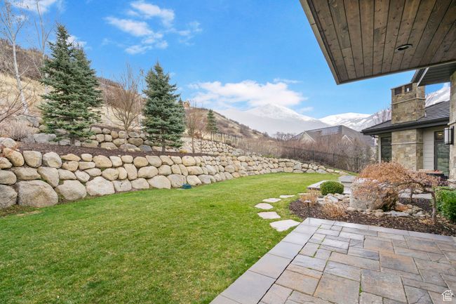 View of yard featuring a mountain view, fence, and a patio area | Image 89