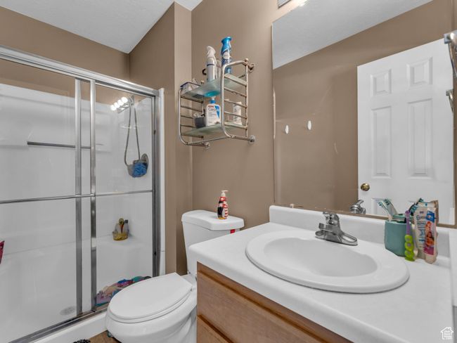 Full bath featuring vanity, toilet, and a shower stall | Image 26