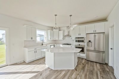 (Photo of an inventory home, actual homes finishes will vary) Open and naturally bright, the home's kitchen space is highly desirable and features a large kitchen island serving as the perfect centerpiece for cooking and entertaining! | Image 3