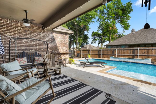 View of swimming pool with a ceiling fan, a patio area, a fenced in pool, and a fenced backyard | Image 29