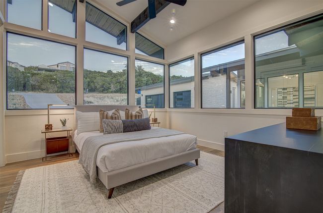 Bedroom with baseboards, wood finished floors, and a ceiling fan | Image 16