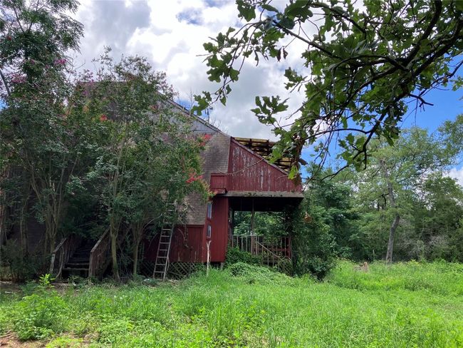 A-Frame House in need of repair or removal. Property is secluded with mature native trees. | Image 7