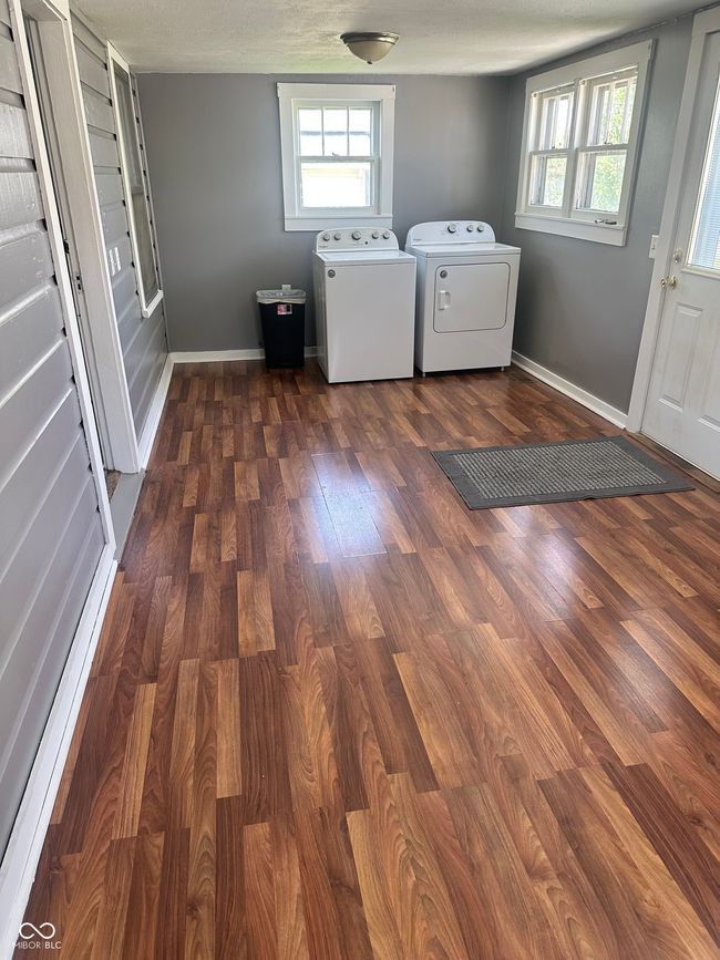 laundry room with washing machine and clothes dryer, dark wood-type flooring, laundry area, and baseboards | Image 11