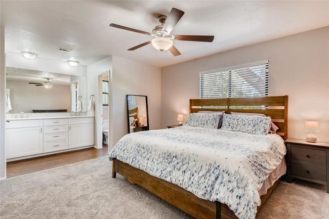Carpeted bedroom with a ceiling fan, a sink, and ensuite bath | Image 13